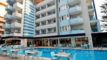 Un hôtel doté d’une piscine, d’un espace extérieur aménagé et de plusieurs balcons.