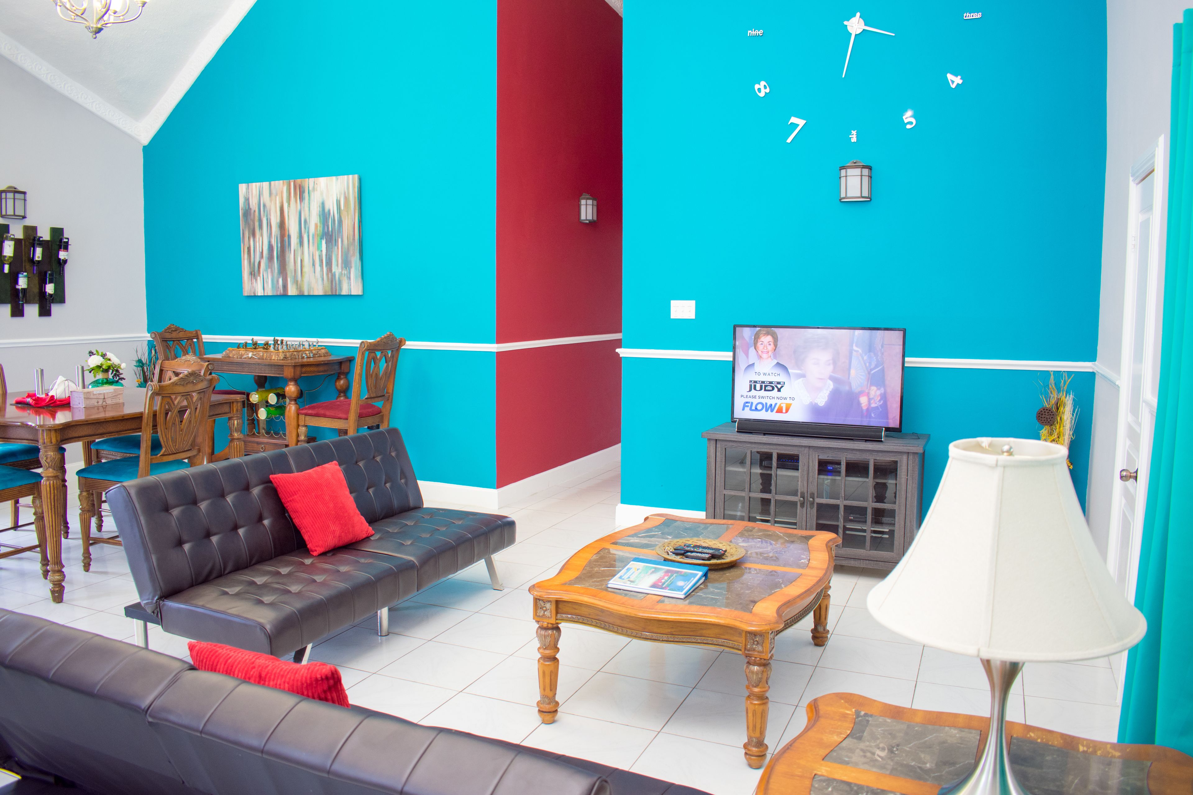 A living room with a sofa, coffee table, and a television.