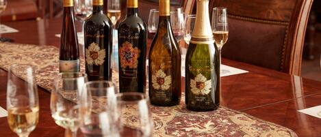 A dining table with several wine bottles and glasses.