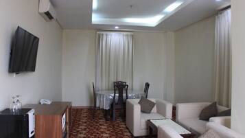 President Suite | Living area | 21-inch LED TV with cable channels, TV