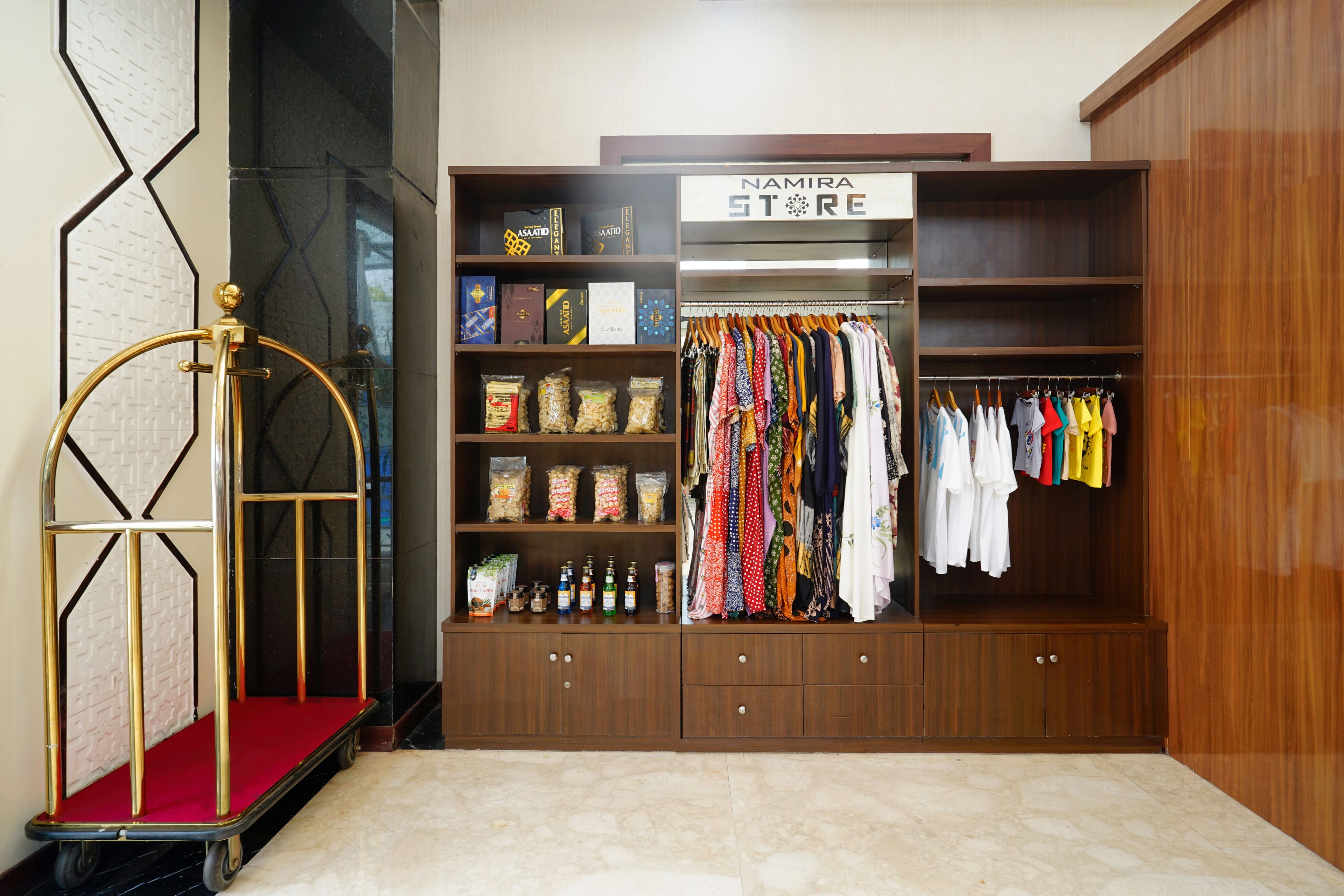 A boutique store with a wooden interior, a clothing rack, and shelves stocked with various items.