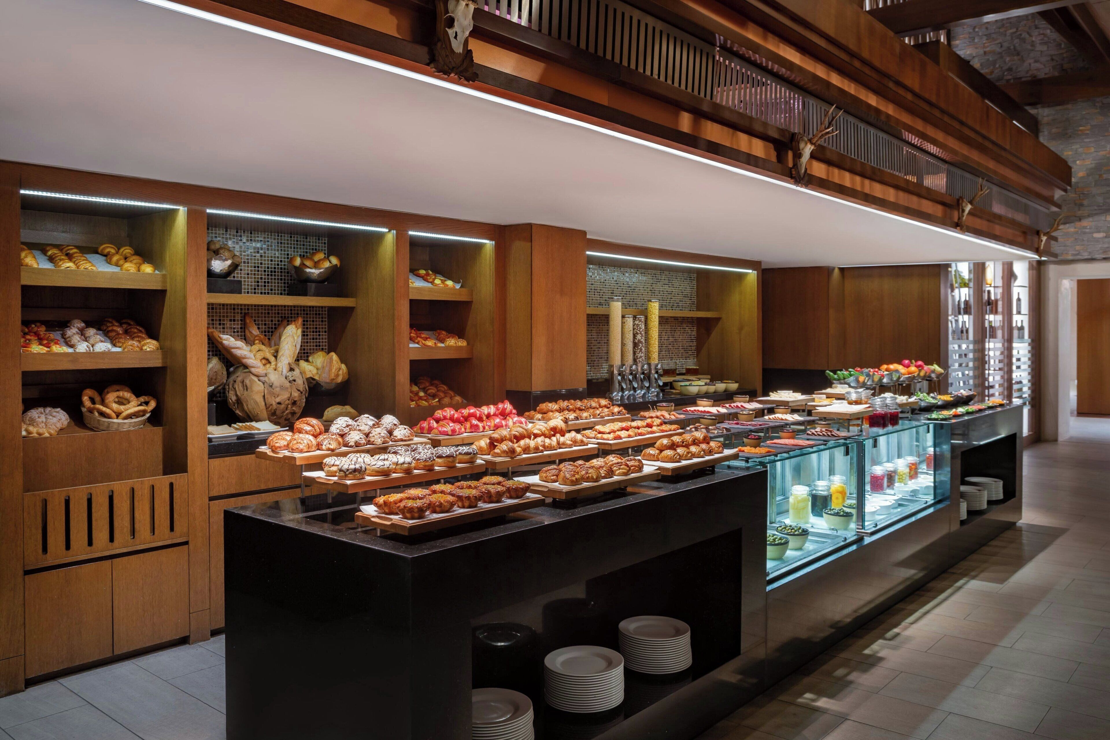 A buffet with various baked goods and beverages.