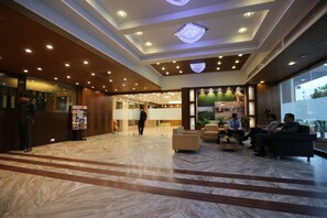 A spacious lobby with a marble floor, wooden accents, and a reception desk. - Silver Cloud Hotel & Banquets Ahmedabad (Ahmedabad)