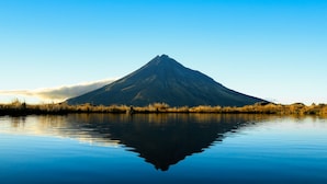 A mountain reflected in calm water with a clear sky. - New Plymouth Top 10 Holiday Park (New Plymouth)