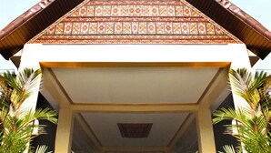 A traditional building with a triangular roof and ornate patterns. - Balairung Hotel (Jakarta)