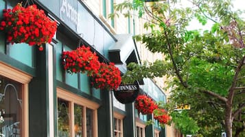 A building with hanging flower baskets and a sign for 'The Rutland Arms.'