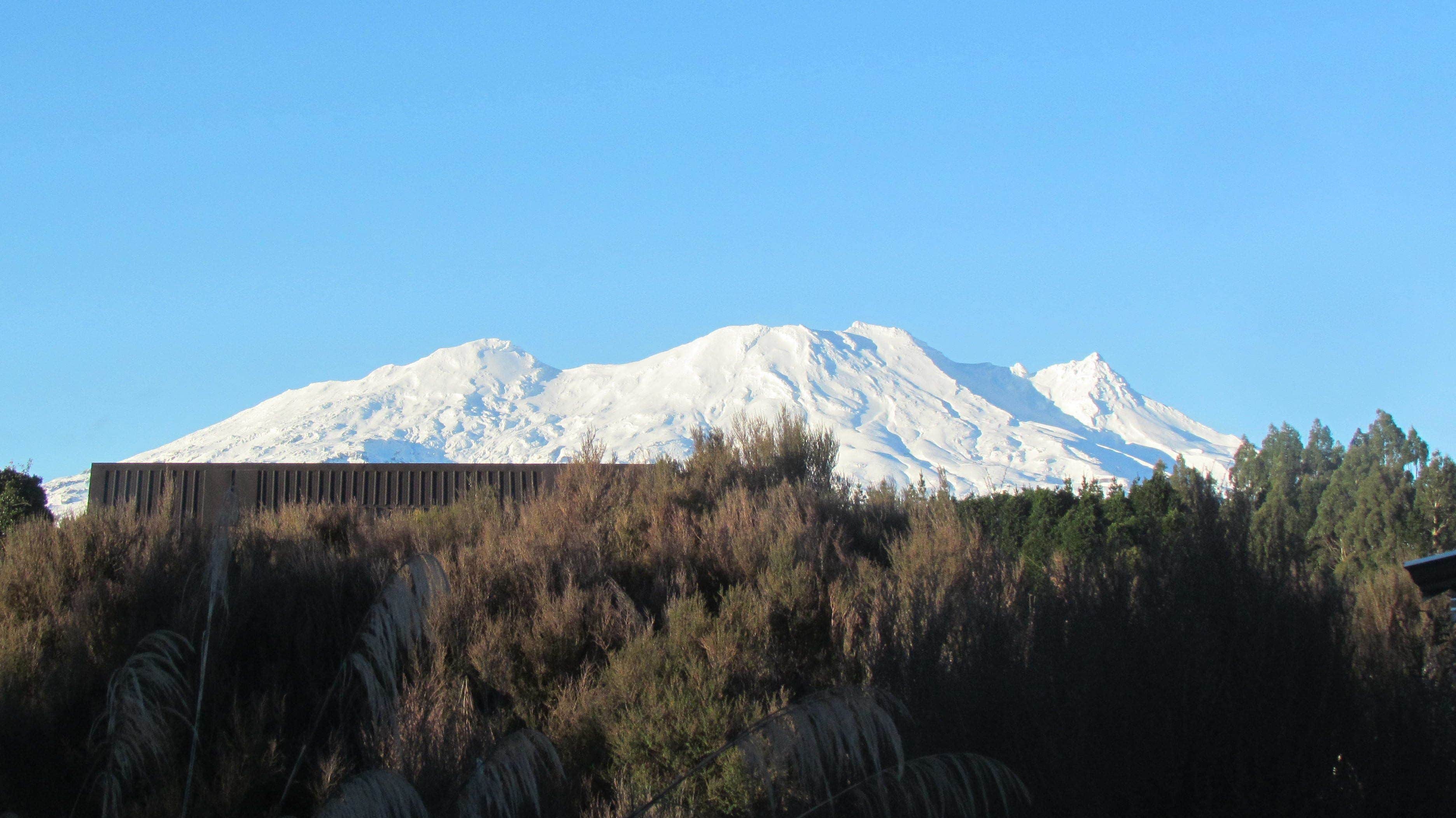 A snow-covered mountain with a clear sky.