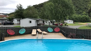 Outdoor pool, open 9:00 AM to 6:00 PM, pool loungers