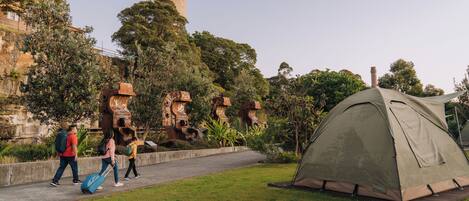 A grassy area with a tent and a pathway.