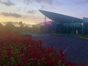 A modern building with a large glass facade and a covered entrance. - Hacienda Motor Lodge (Palmerston North)