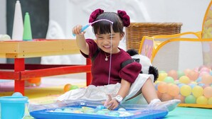 A child playing with toys on a mat. - Metland Hotel Cirebon (North Cirebon)