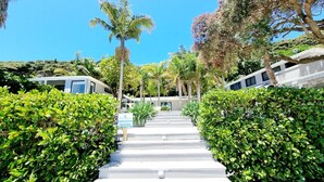 A pathway leading to a building with a sign indicating 'Guests Only'. - The Beach House (Kawau Island)