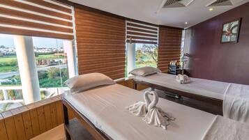 Relax in a serene space with a large bed, wooden bench, and stylish table.