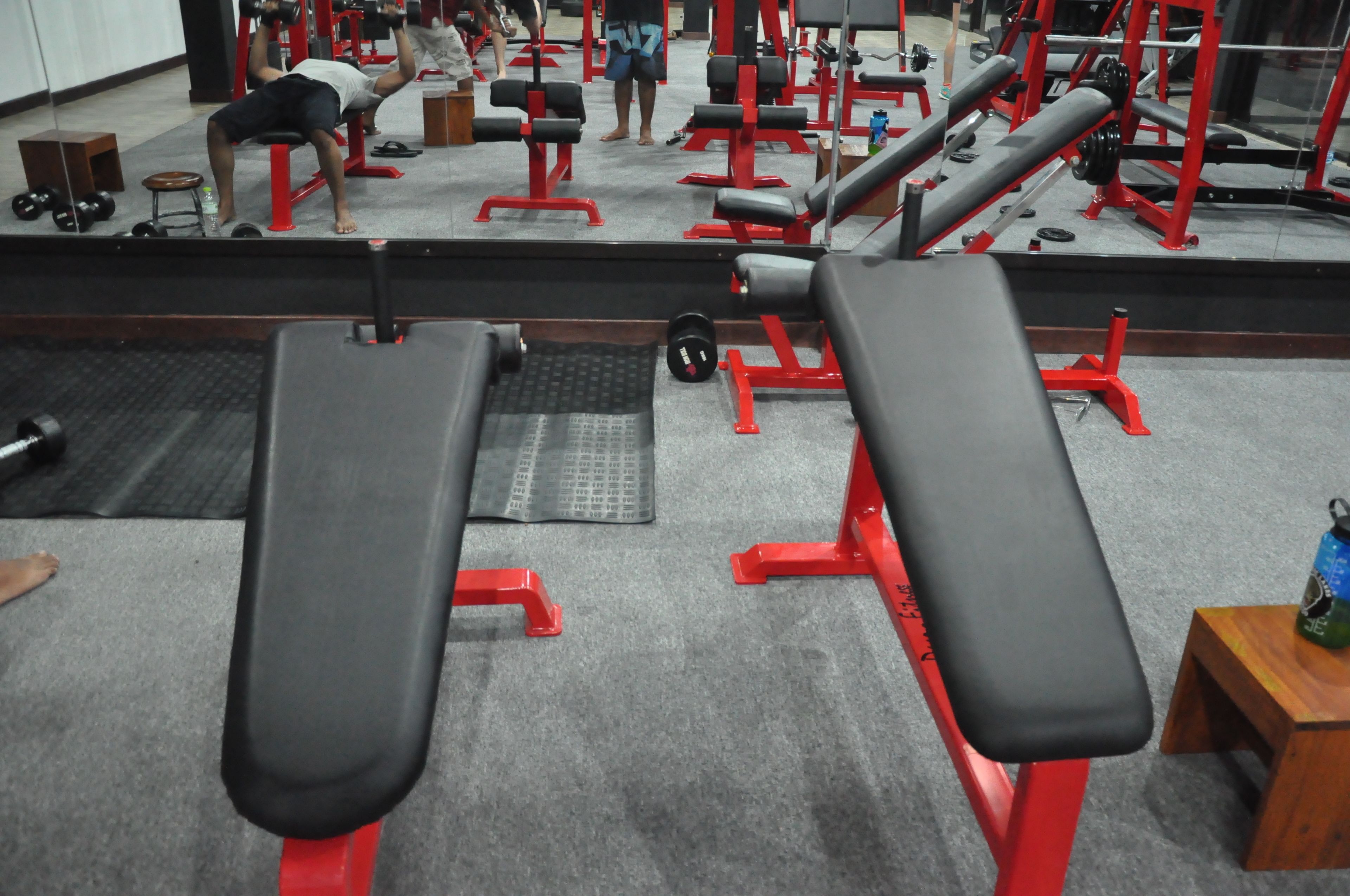 A gym with benches, weights, and exercise equipment.