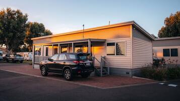 A modern single-story building with a car parked in front.