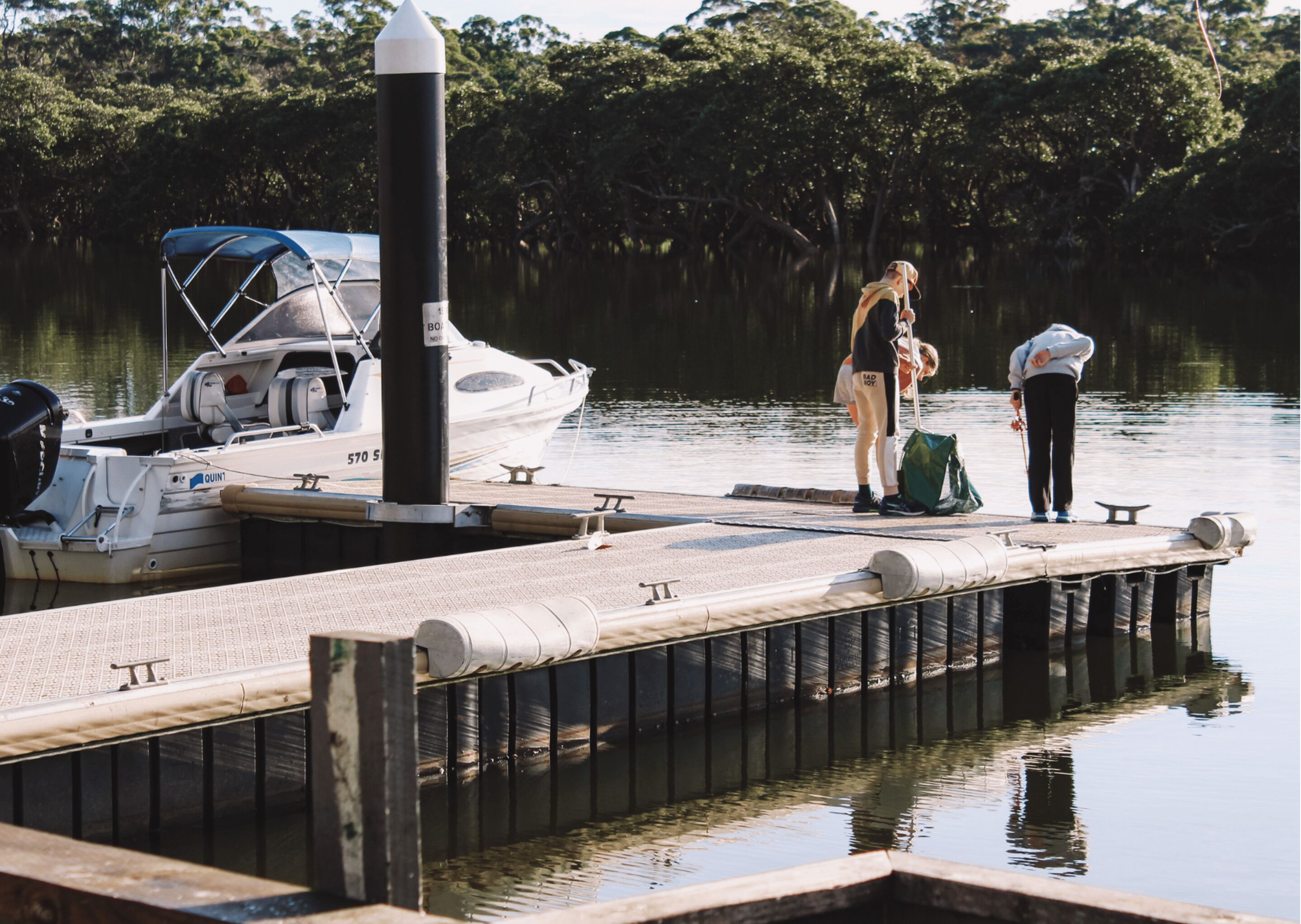 A dock with a boat and a person standing on it.