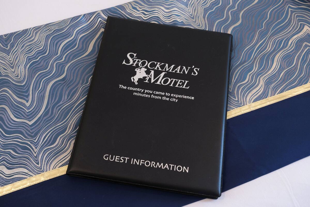 A black booklet titled "Stockman's Motel" with "GUEST INFORMATION" at the bottom.
