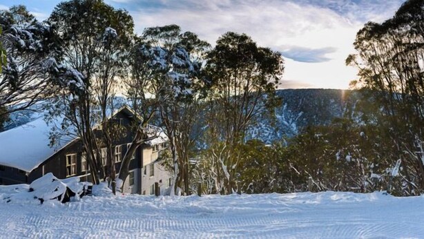 A snow-covered landscape with a house surrounded by trees. - Attunga Alpine Lodge and Apartments (Falls Creek)