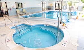 A swimming pool with a tiled edge and a lifeguard stand.