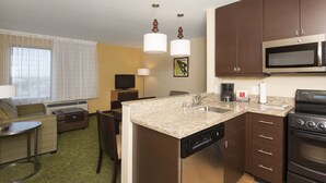 A compact hotel room with a kitchenette, a dining area, and a living space. - TownePlace Suites by Marriott Lexington South/Hamburg Place (Lexington)