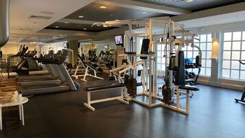 A gym with treadmills, weight machines, and exercise equipment.