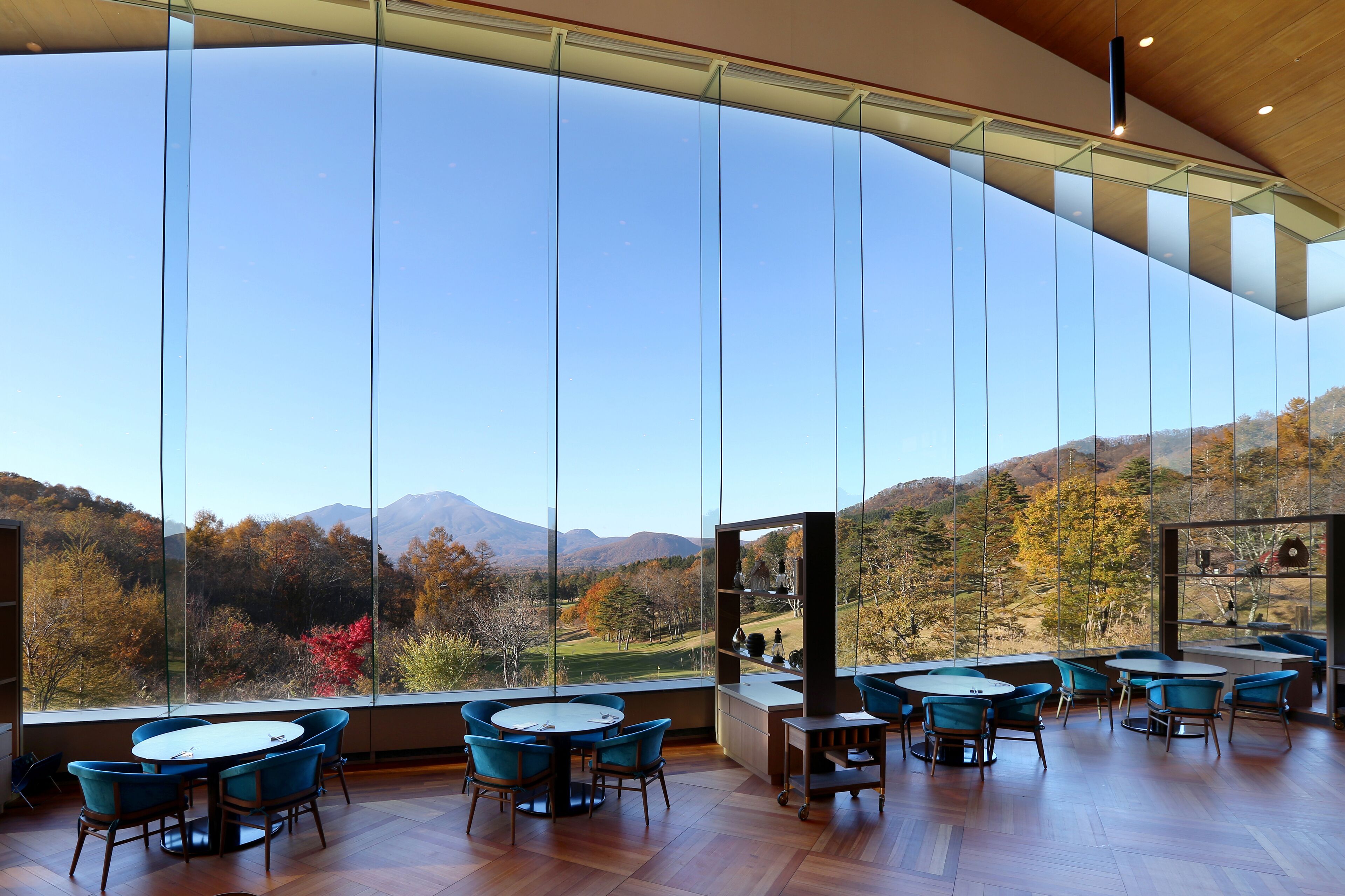 Un intérieur moderne avec de grandes fenêtres donnant sur un paysage montagneux.