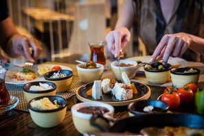 A dining table with various dishes and a pitcher of tea.