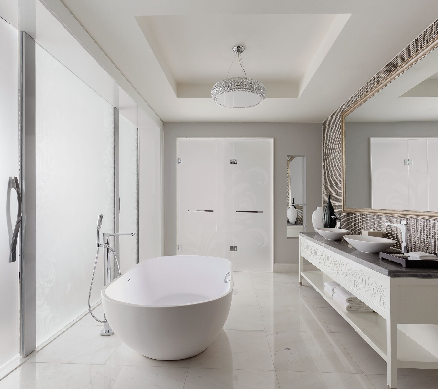 A modern bathroom with a freestanding bathtub, a large mirror, and a walk-in shower.