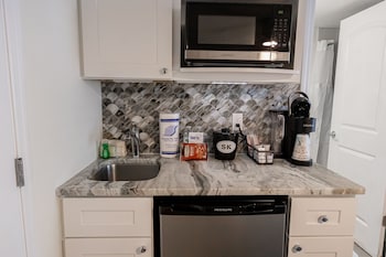 Studio, 1 Queen Bed | Private kitchenette | Coffee/tea maker, toaster, cleaning supplies, paper towels at Siesta Key Beachside Villas