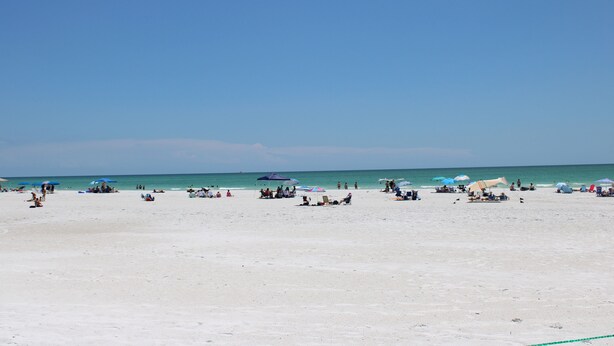 A beach with people sunbathing and swimming. - Siesta Key Beachside Villas (Siesta Key)