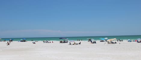 Beach nearby, white sand, beach towels