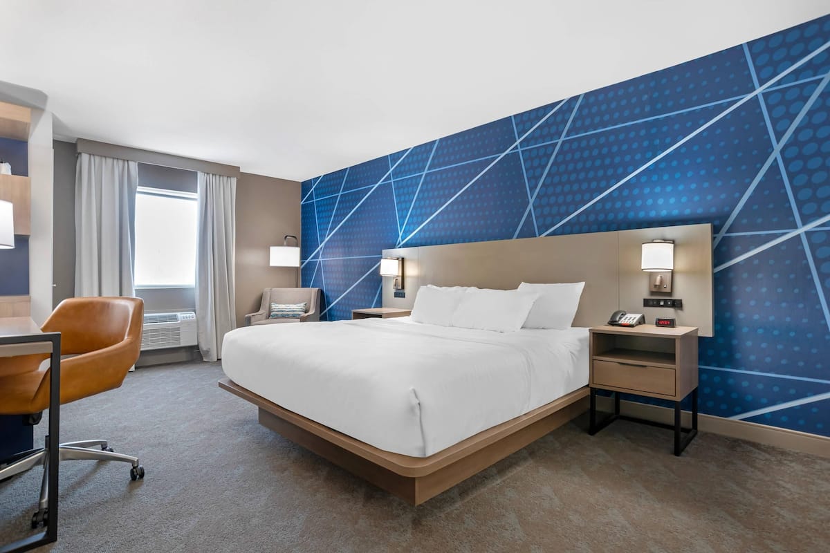 Desk, laptop workspace, blackout drapes, iron/ironing board