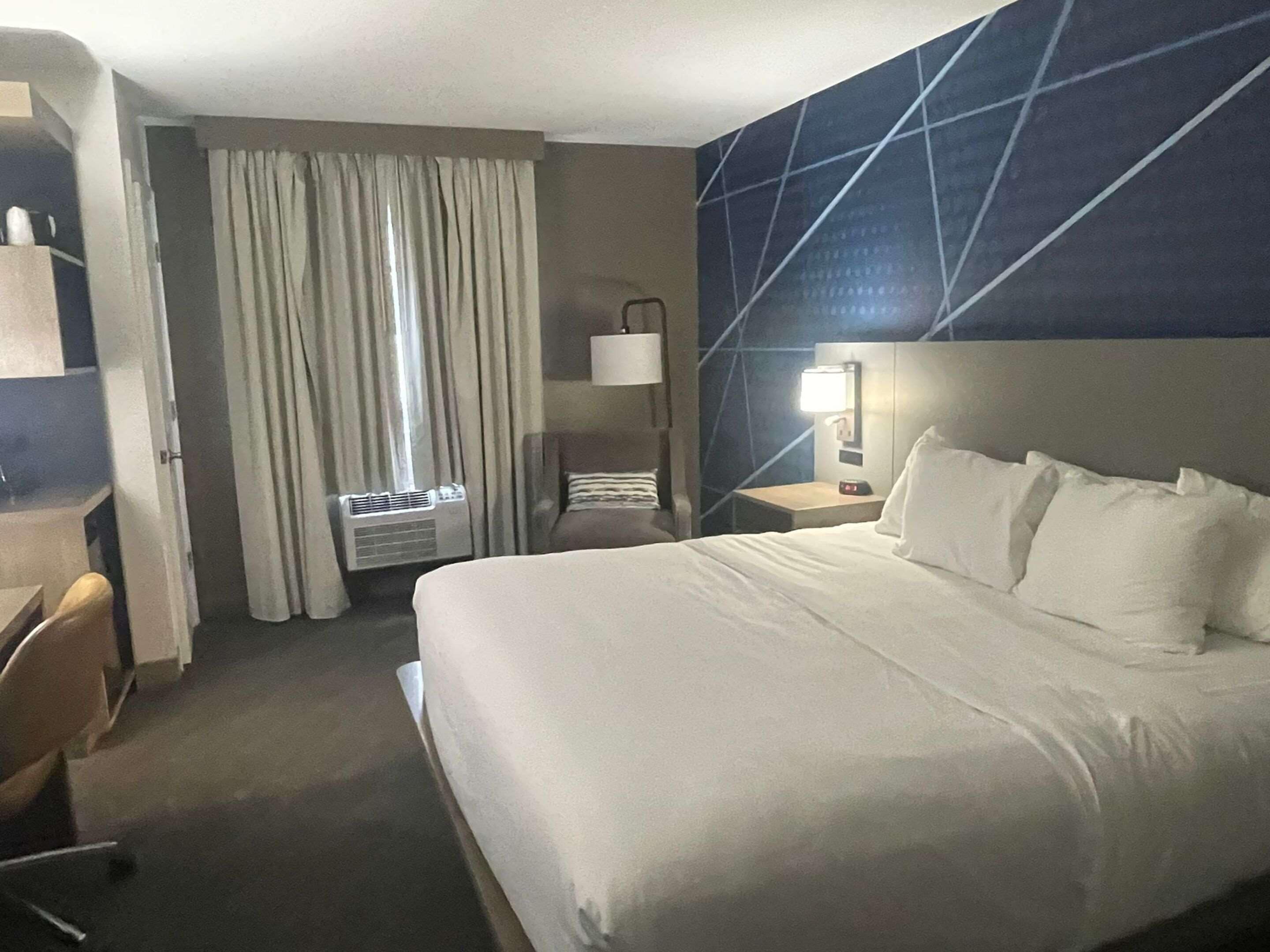 Desk, laptop workspace, blackout drapes, iron/ironing board