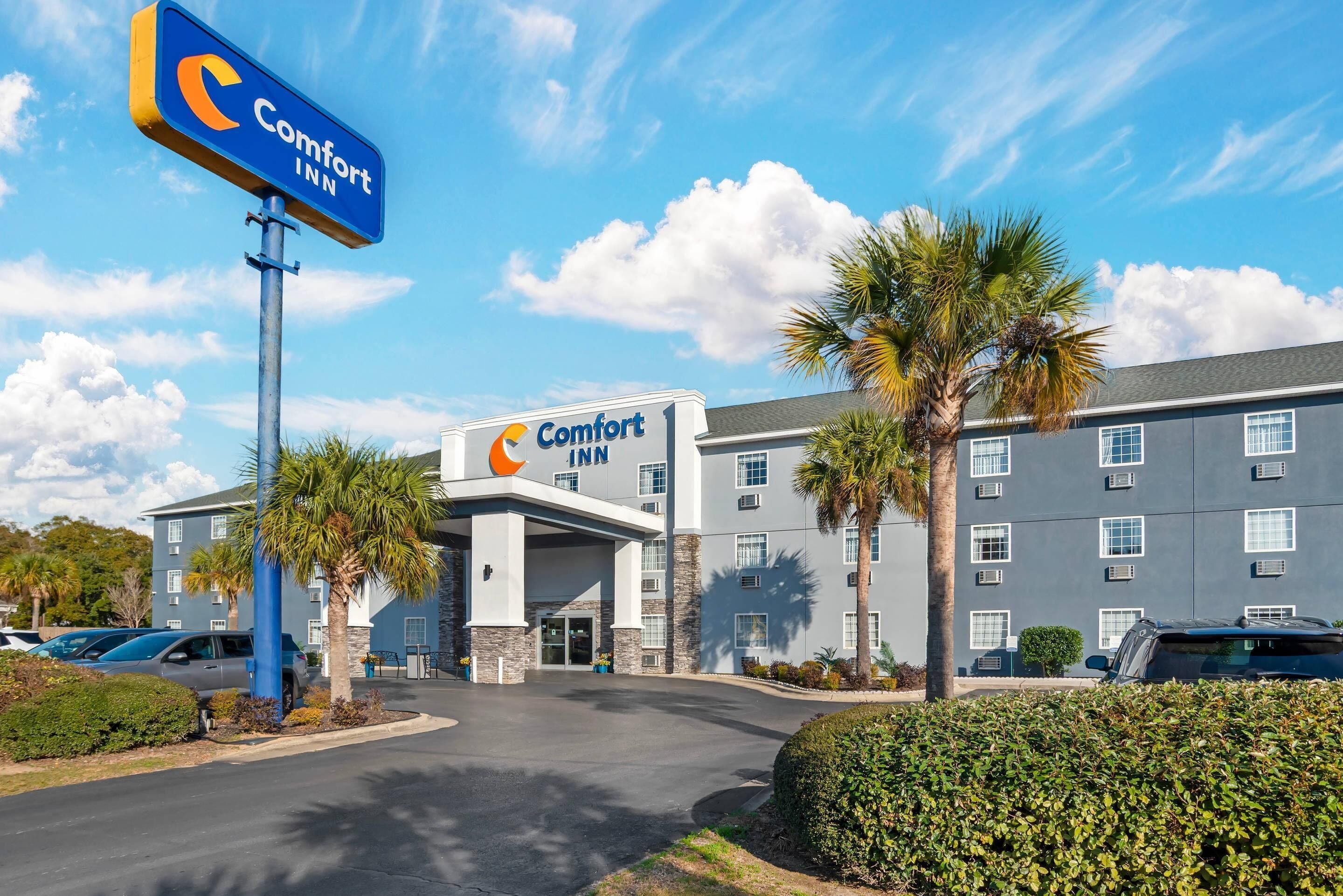 A Comfort Inn hotel with a modern design, featuring a prominent sign, a parking lot, and a well-maintained exterior.