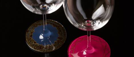 Two wine glasses with unique designs on their bases.
