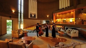 A spacious lobby with high ceilings, large windows, and a grand staircase. - Hoshino Resorts KAI Matsumoto (Matsumoto)