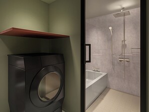 Un bagno moderno con lavatrice integrata, una vasca e una doccia.