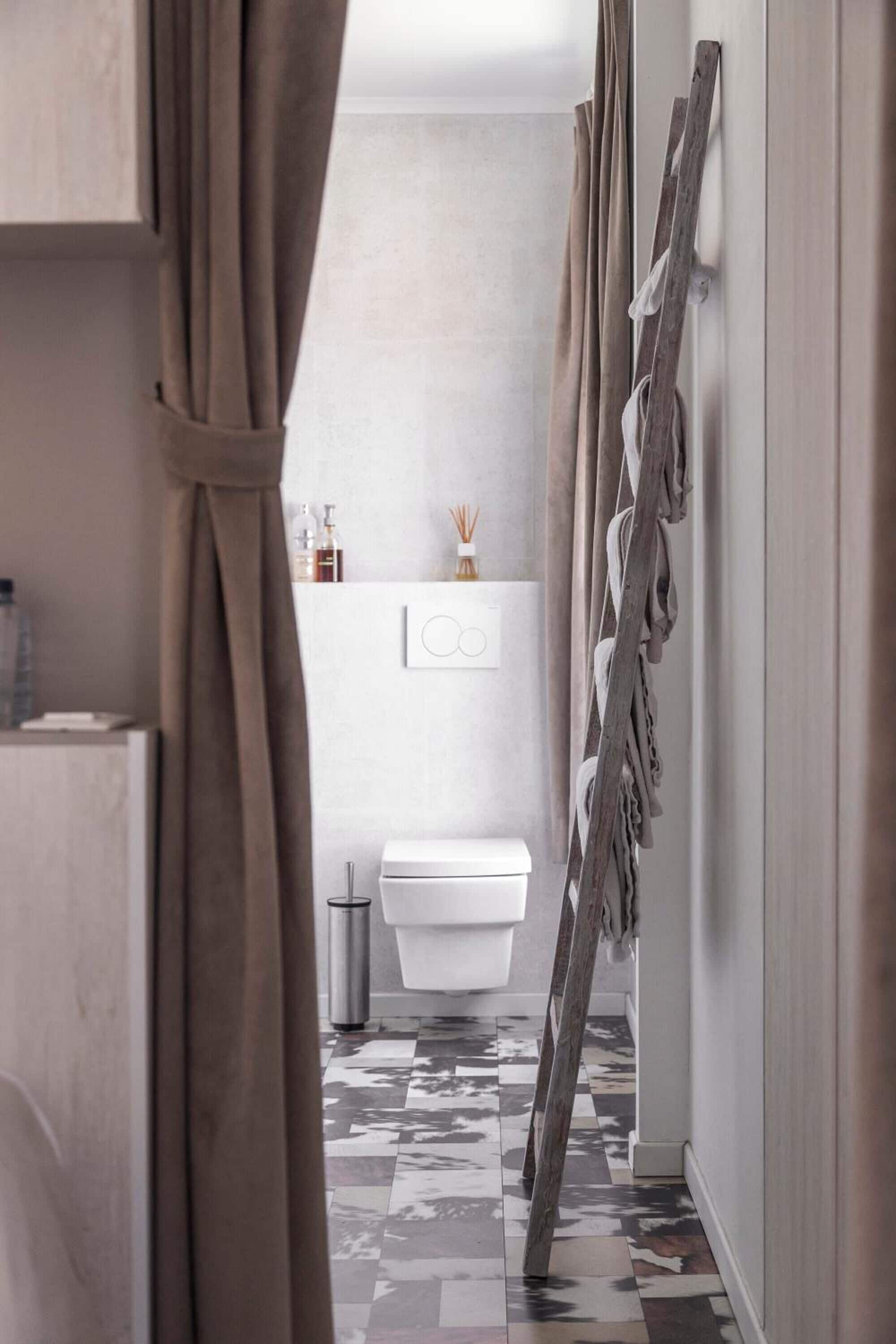 A narrow hallway with a patterned floor, a white toilet, and a wooden ladder leaning against the wall.