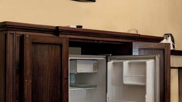 A wooden cabinet with a large Netflix logo on the wall above it.