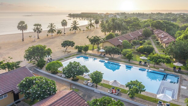 A resort with a swimming pool, beach, and palm trees. - Amethyst Resort Passikudah (Pasikuda)