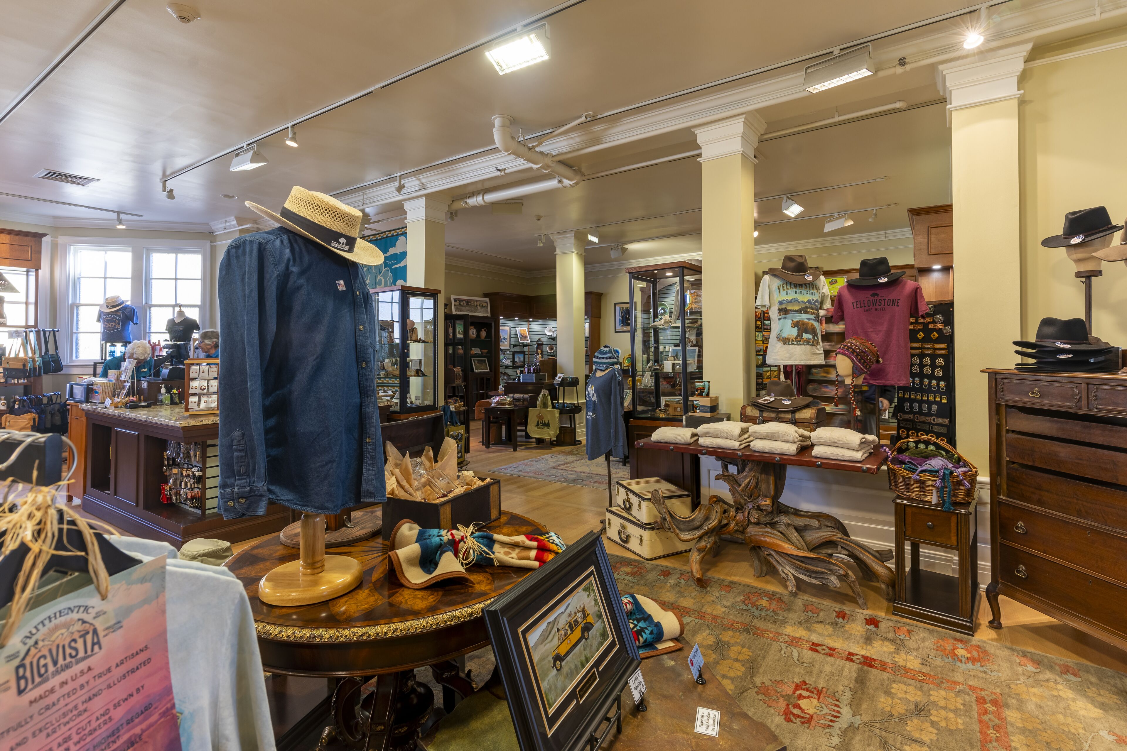 A store interior with various items on display, including hats, clothing, and accessories.