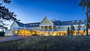 A large, multi-story hotel with a prominent entrance, covered patio, and multiple windows.