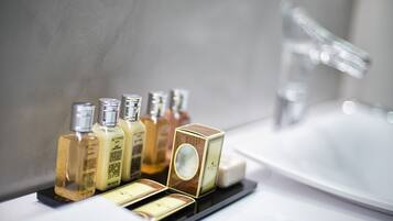 A bathroom with a sink and toiletries on a tray.