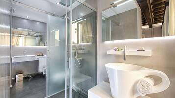 Shower, designer toiletries, hair dryer, slippers