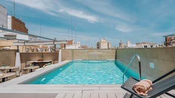 Relax by the pool surrounded by a deck and lounge chair.
