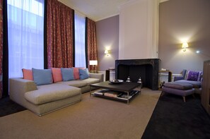 Suite, 1 King Bed (Canal House) | Living area | Flat-screen TV, pay films