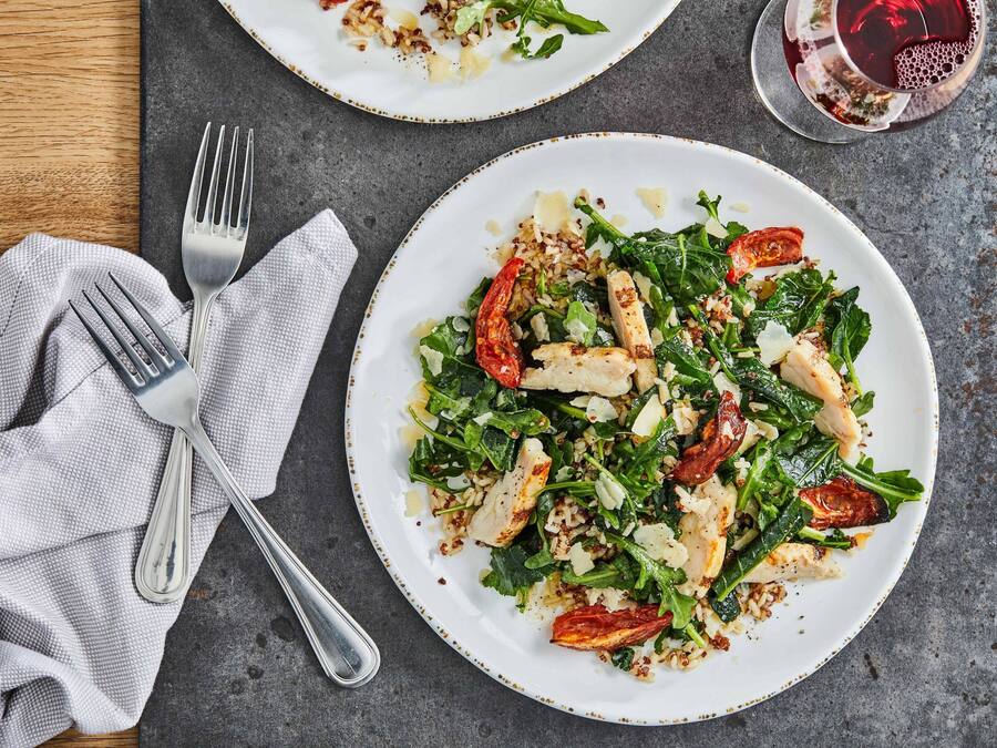 A plate of food with a fork and a napkin on a table.