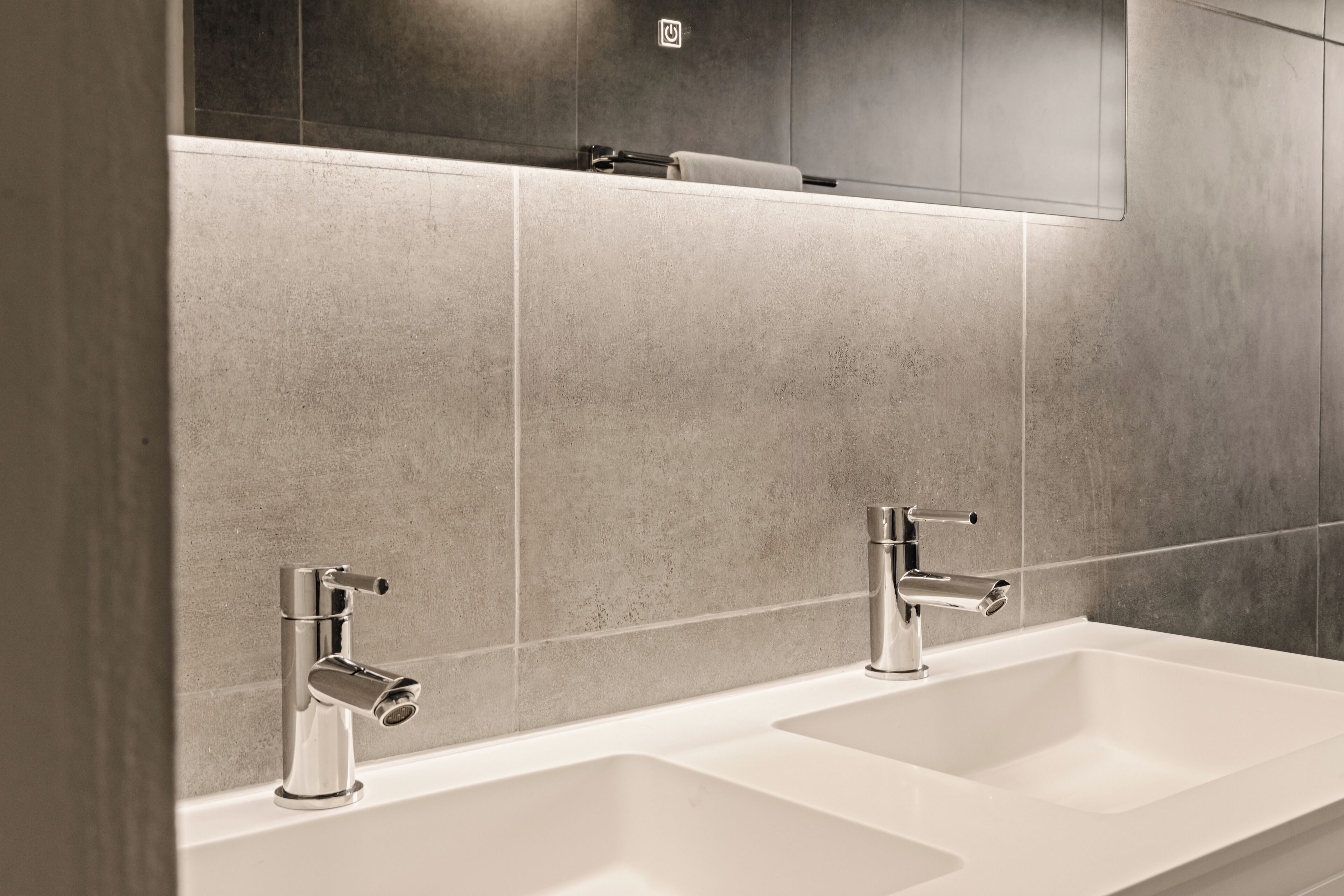 A modern bathroom with two sinks and a mirror.