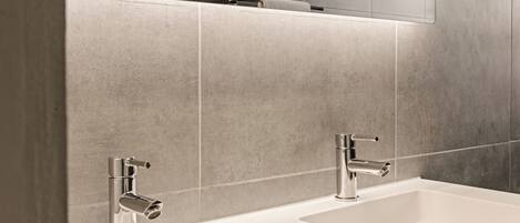A modern bathroom with two sinks and a mirror.