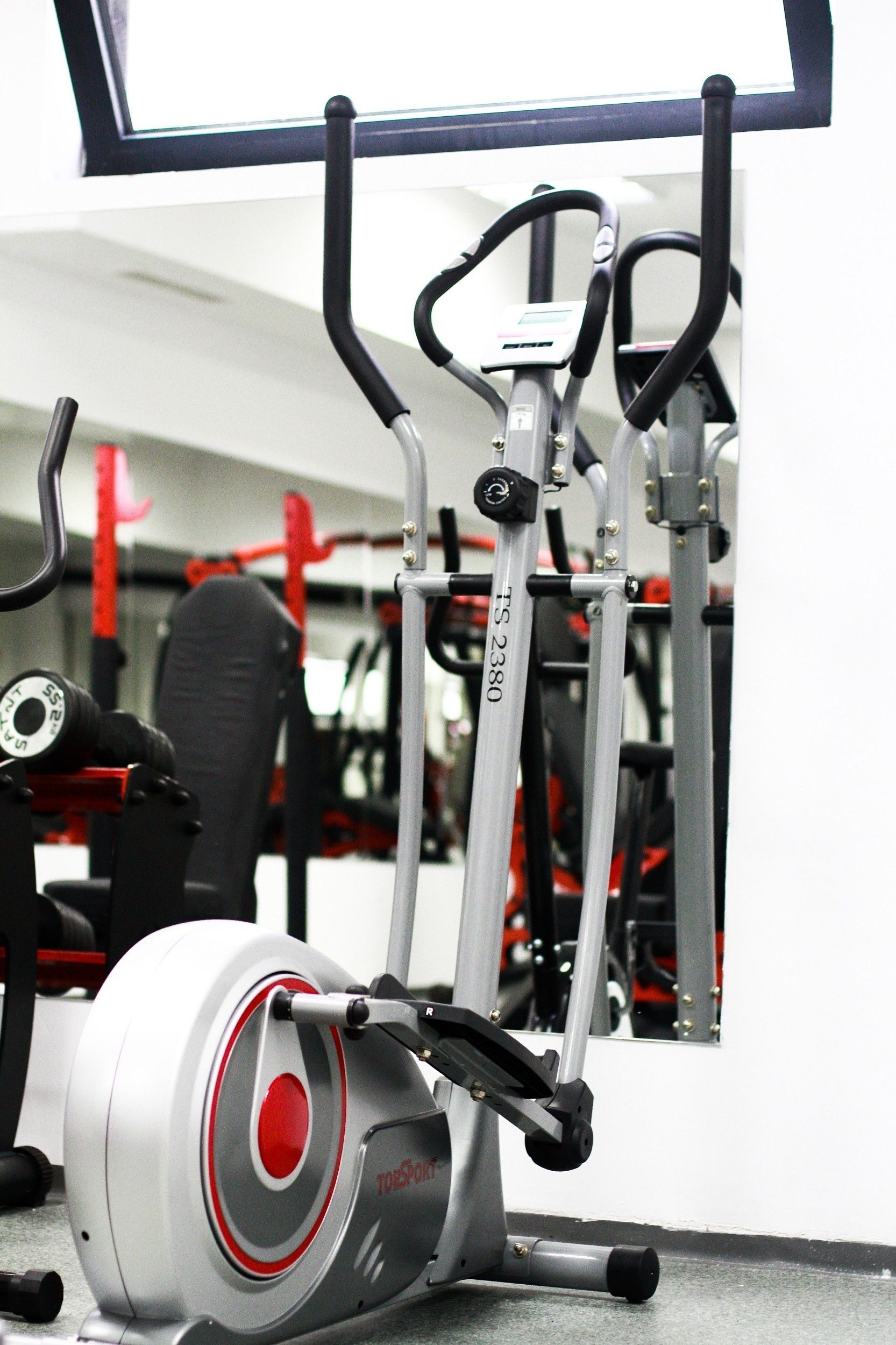 A stationary bike with a digital display and a red circular dial.